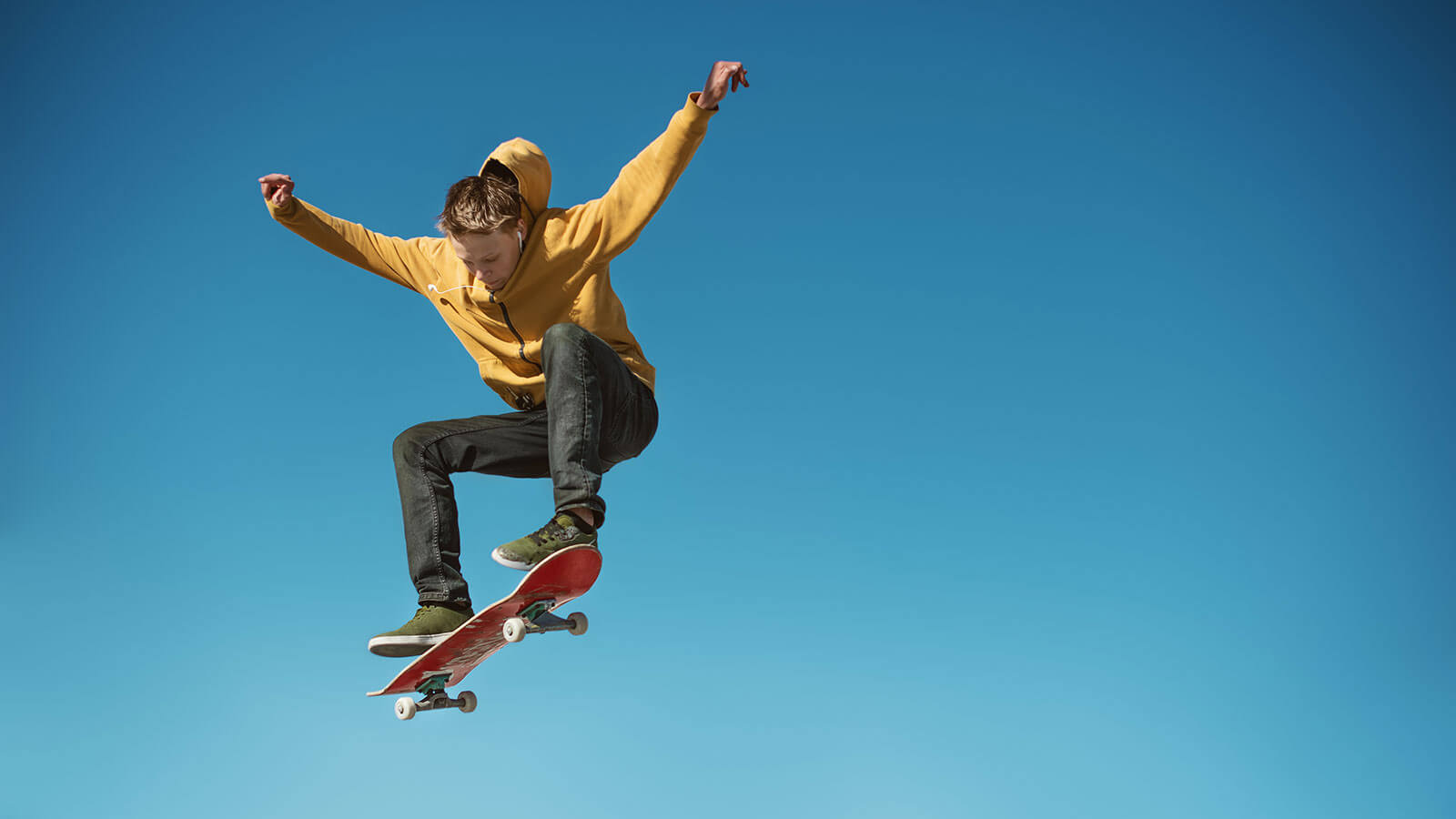 Skateboarder practicing an ollie on flatground in an urban spot