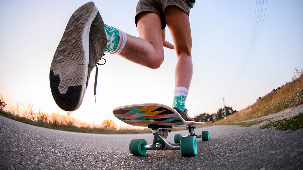 Skateboarder repeating frontside 180 drills on flatground